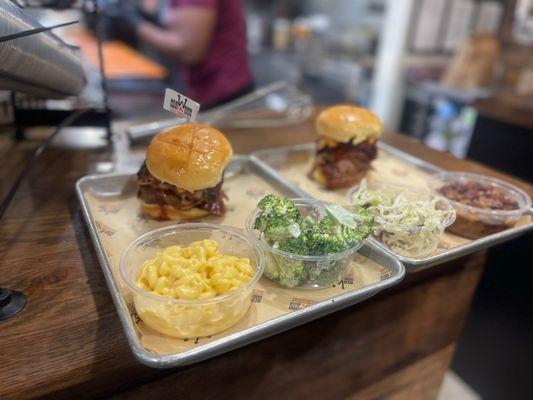 Brisket sandwiches with mac n cheese and delicious broccoli - and on the other plate baked beans and slaw