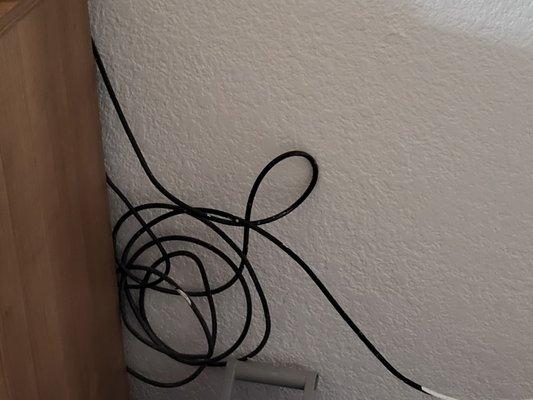 Wires to the TV. As the black came out, they painted it white. Like it would hide it.