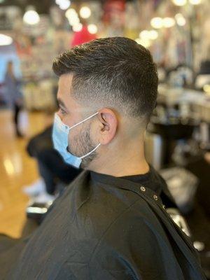 Side profile of medium bald fade