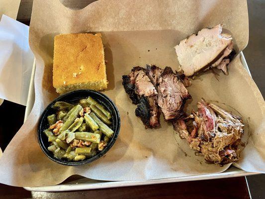 3- meat sampler with green beans and a piece of cornbread