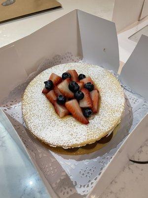 Dulce de leche alfajor tart with cream and berries