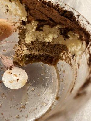 Savoring the delicious last few bites of TIRAMISU. Now in a plastic container. And a fluffy layer of chocolate.