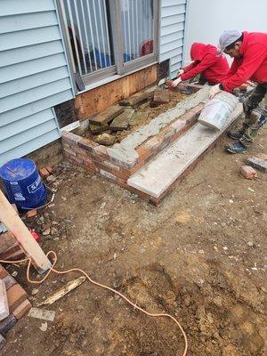 Building new steps with brick and limestone