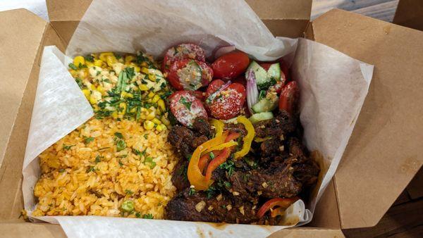 Brisket with rice, corn, tomato salad. Brisket was extremely salty, would avoid!