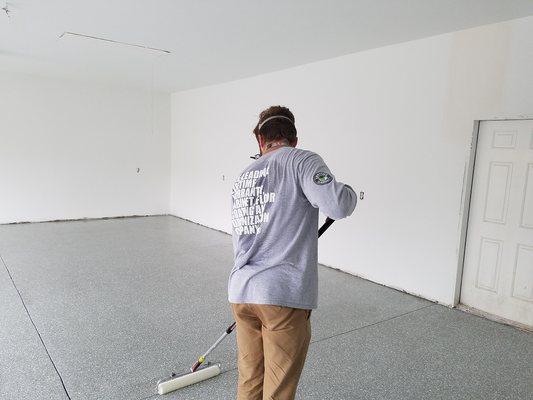 Installing topcoat over 1/4" Smoke flake and base epoxy flooring.