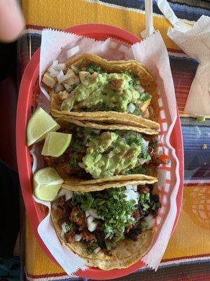 Pastor, chicken, and chorizo tacos on soft corn tortillas.