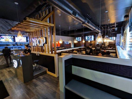 Inside. View of bar, hostess stand, and dining room from the front of the house / waiting area.