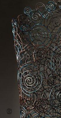 Close up of woven copper wire vessel