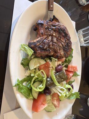 Pork chop with Greek side salad.