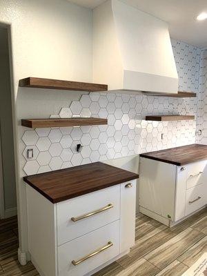 Walnut butcher block counters with matching walnut floating shelves