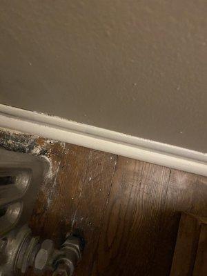 Dirty baseboard and no cleaning behind radiator