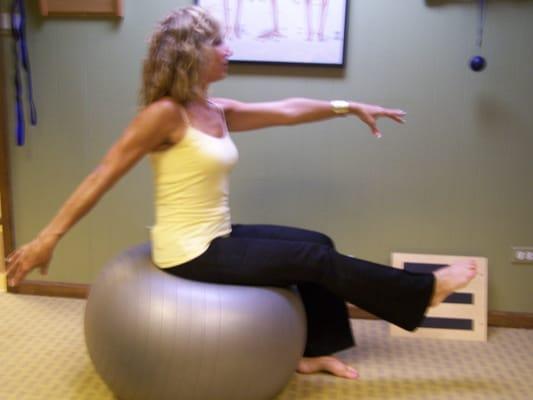 Toni demonstrating balance work on a Swiss ball