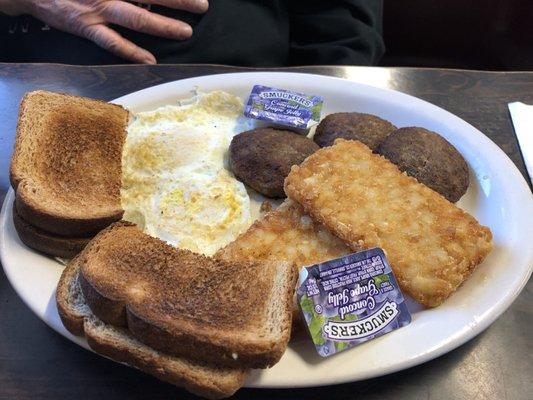 Eggs, sausage patties, hash browns and toast.