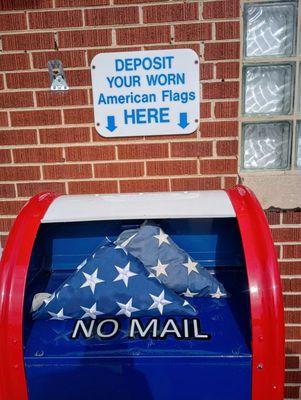 Depositing folded worn American Flags