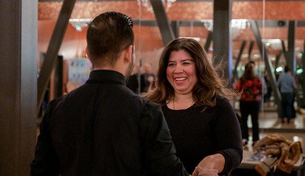 Dance students share a smile on the dance floor.