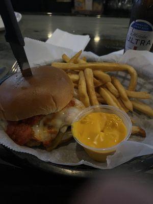 Hot Sausage Sandwich with fries and a side of nacho cheese sauce to dip the fries into.