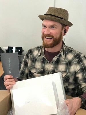 All smiles from Andrew when he opens a big box of chocolates and treats that he received from a happy candidate