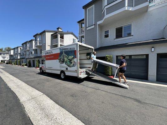 Movers moving furniture into Uhaul