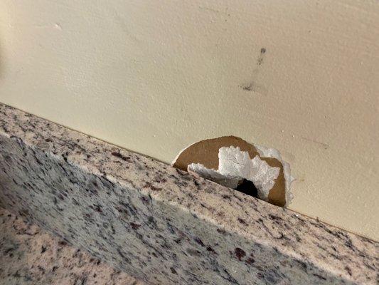 This isn't from removing old countertops - this is from when they were installing the new backsplash. The person pushed debris into the wall