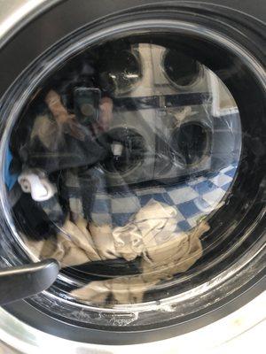 No visible water in largest washing machine. Visible dry clothes 5 minutes into the wash.