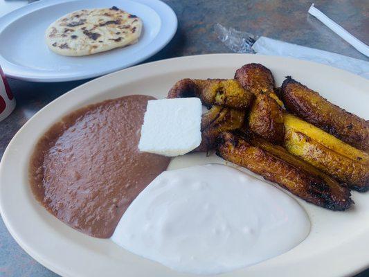 Platanos Fritos con queso y crema(Salvi sour cream) And a pupusa revuelta