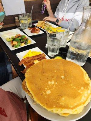 Plate size pancakes with scrambled egg & bacon