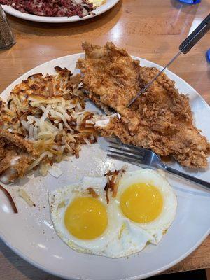 Burnt hash browns with runny fried eggs that I did not ask for.