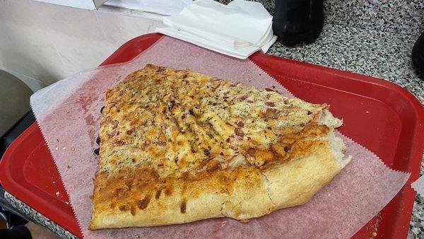 Enormous delicious slice of pizza