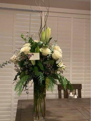 Stunning arrangement from one of my clients that includes white roses, lilies, white curly willow tree, greenery, gorgeous vase!