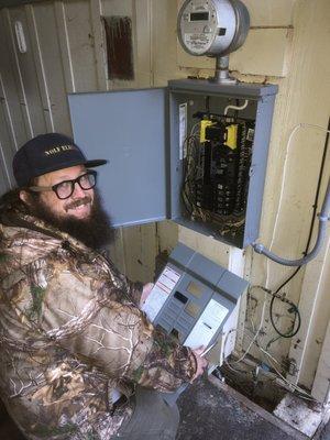 Brian installing another circuit breaker box with a generator switch and plug.