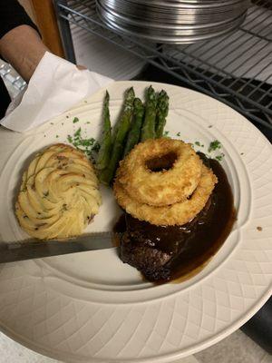 Center cut filet with our homemade Demi glaze  Topped with onion rings