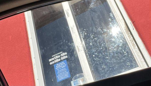 A very dirty window, opened by a breaded dirty employee