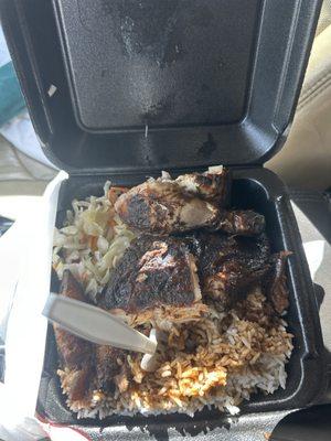 Jerk chicken with white rice, steamed cabbage and plantain.