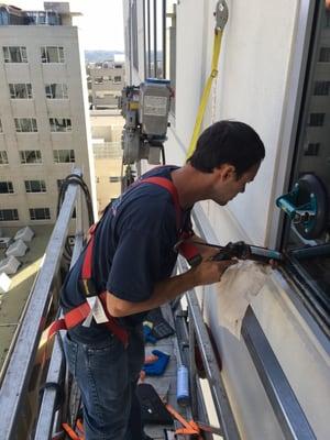 One of our lead glazier putting on the final touches to seal a glass replacement.