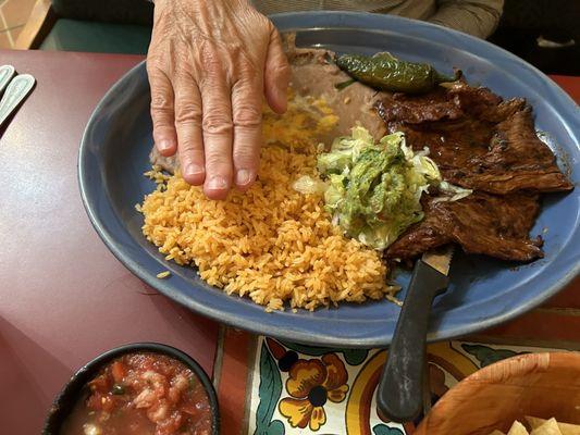 Carne Adobada. The hand is simply to demonstrate the size of the plate.