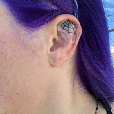 Ear spiderweb tattoo