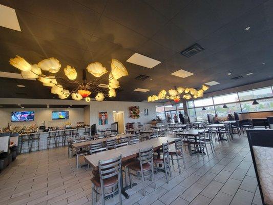 Clean dining room. Airey with lighting and lots of windows