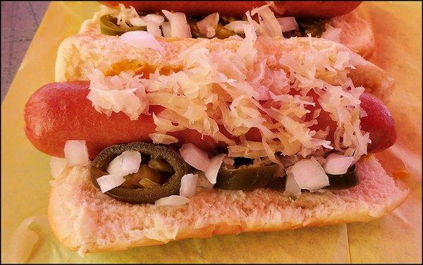 One of my "Regular Dogs," showing the juicy dog, the fresh bun, along with the mustard, sauerkraut, diced white onion and diced jalapeno.