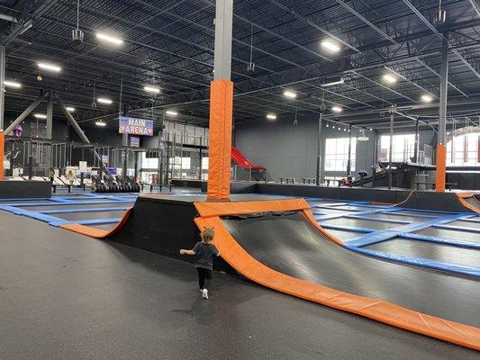 Trampolines with swinging bars course in background