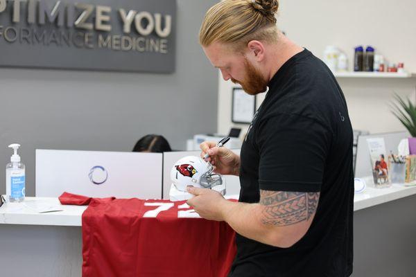 Hjalte Froholdt of the Arizona Cardinals Football Team Signing a Jersey to hang up in our office in support