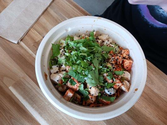 Chicken bowl with various vegetables and toppings