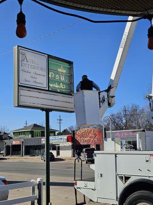 This sign is being converted to LED bulbs allowing it to be brighter and more legible.