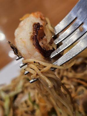 Close-up of a fork with a shrimp from the Combo Lo Mein.