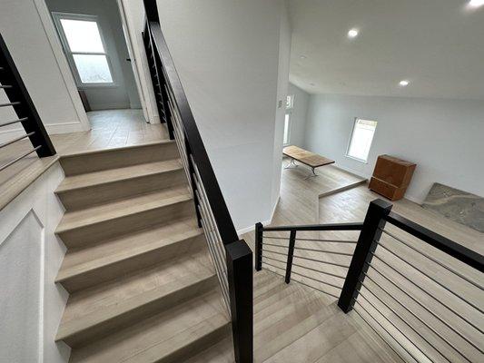 Stairs remodeling, hardwood floor, wood handrail, cable style, stain handrail and new skirt.