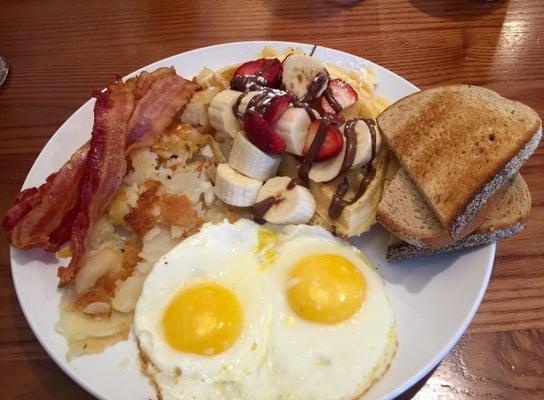 A combo bfast plate~ 2 eggs any style, home dries and bacon. The fresh waffle w// fruit & Nutella! YUM