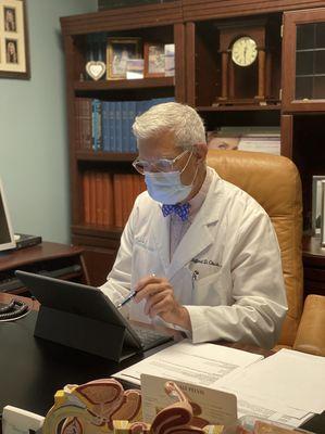 Dr. Gluck working in his office.