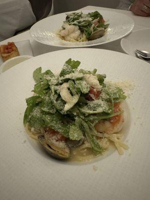 Linguine with clams, shrimp, crab, arugula, and tomato