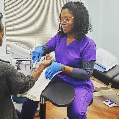 Occupational Therapist performing hand therapy with a patient.