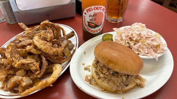 Pork sandwich, slaw and onion rings.