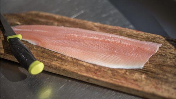 Staff filleting fish that's caught